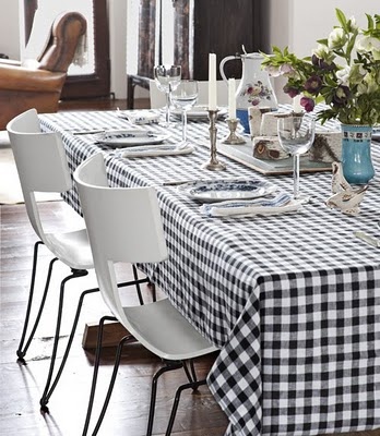 pairing modern chairs with a classic gingham tablecloth provides a fresh twist